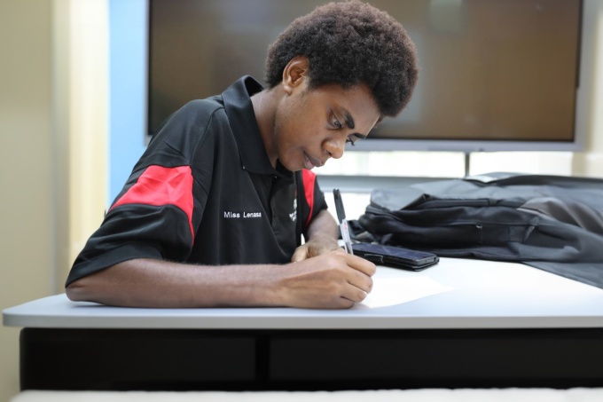 Velian studying at the university. Credit: Rachel Tarsan / Save the Children